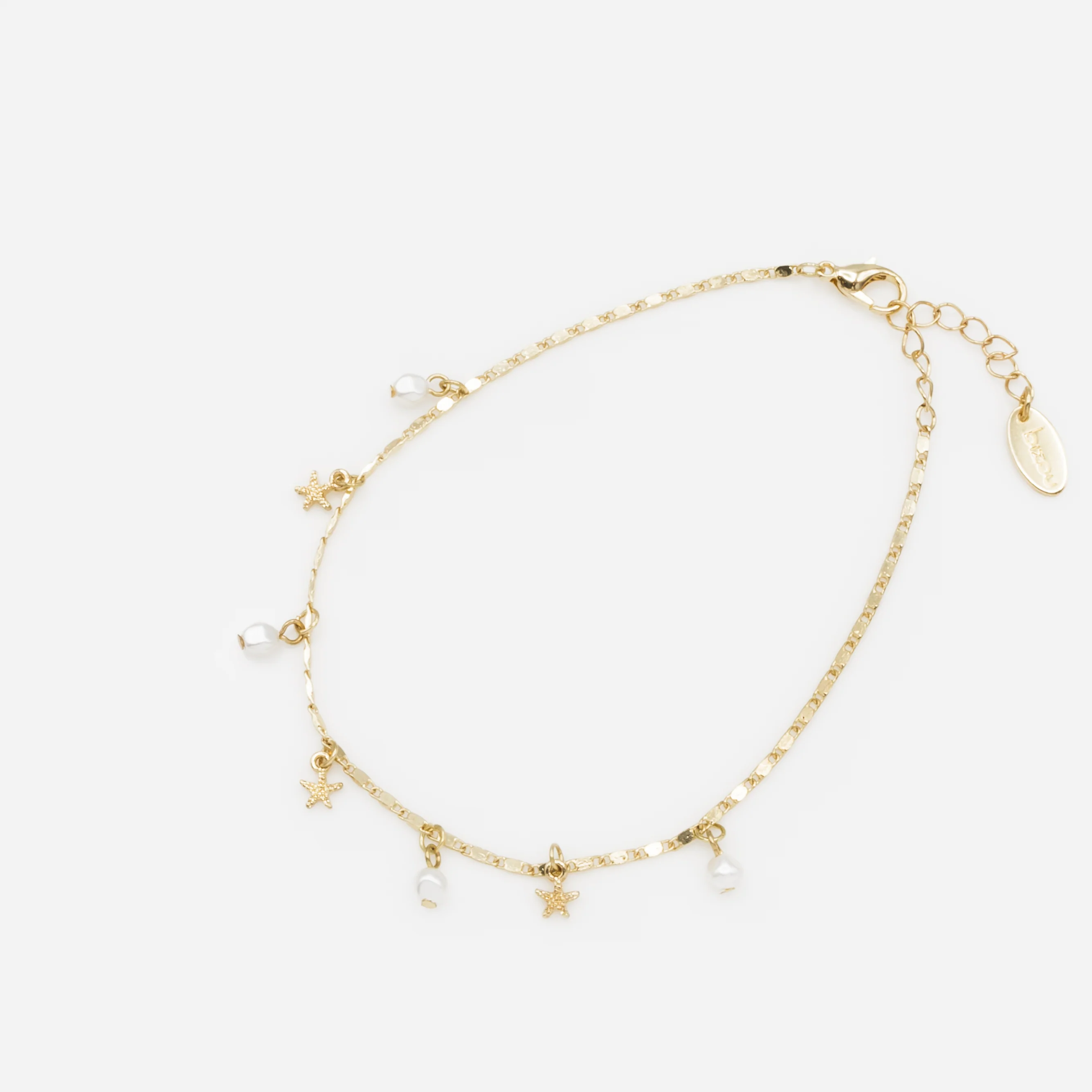 Chaîne de cheville dorée avec perles et étoiles de mer