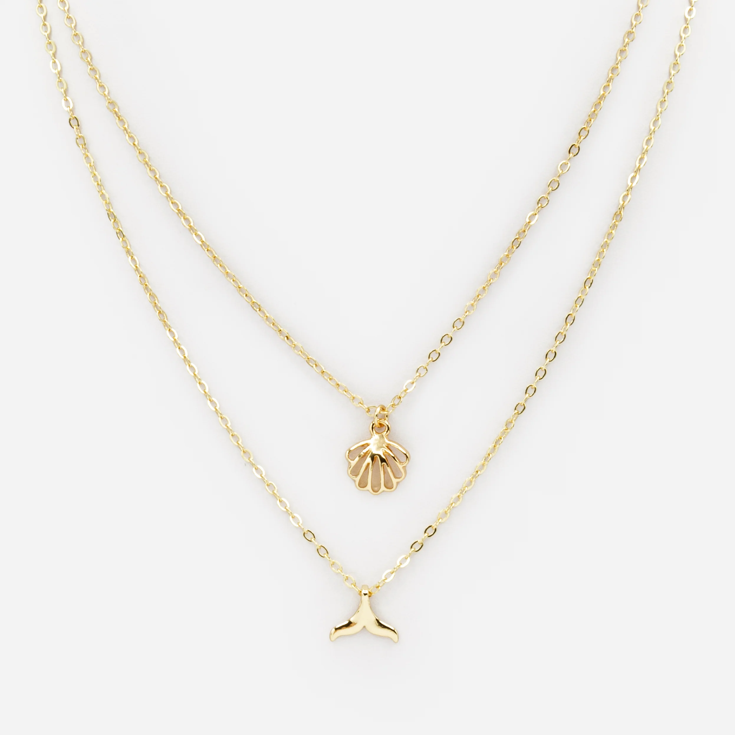Collier doré double chaîne avec breloques de la mer