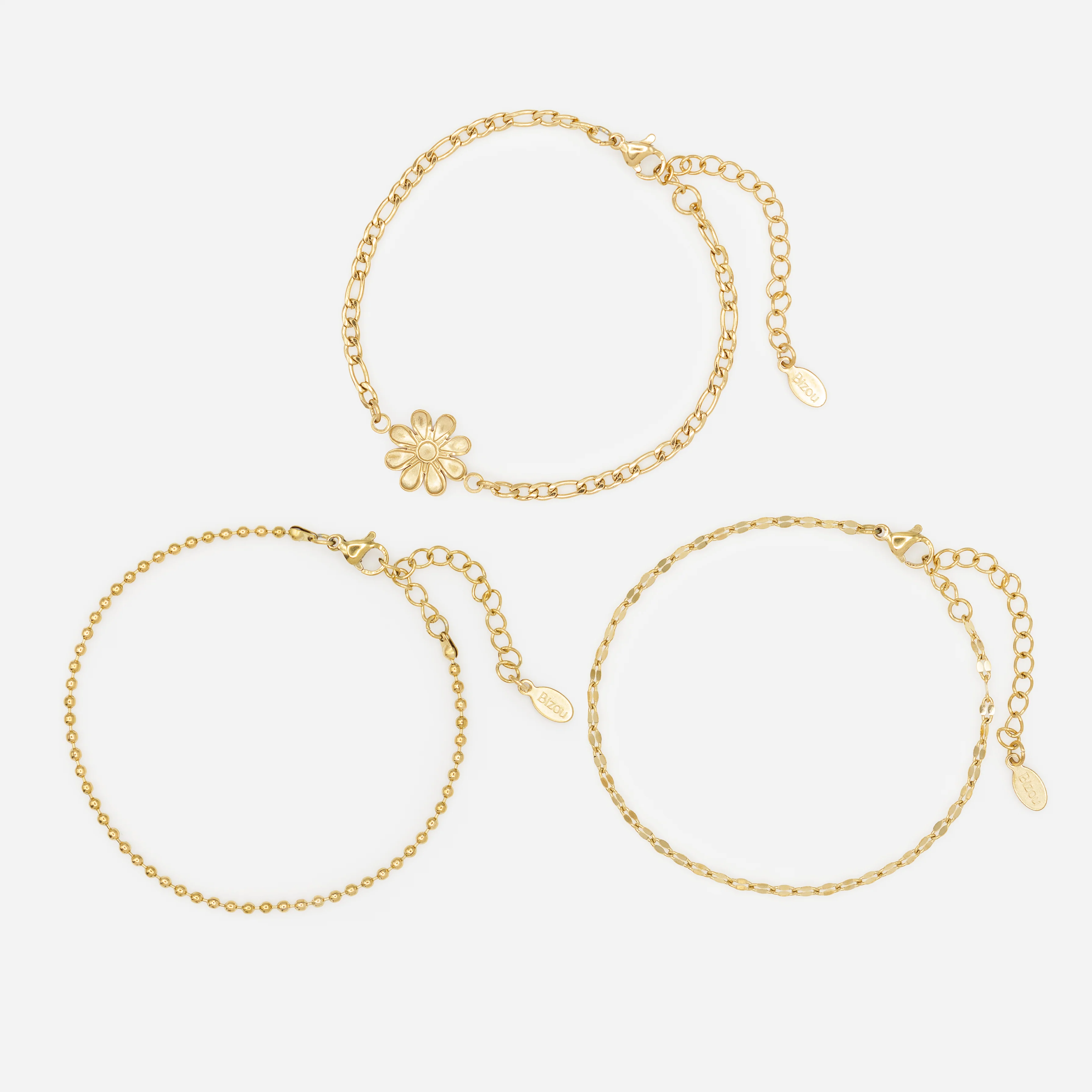 Ensemble de trois bracelets dorés avec fleur en acier inoxydable